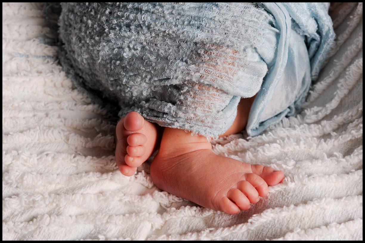 baby feet with blue blanket