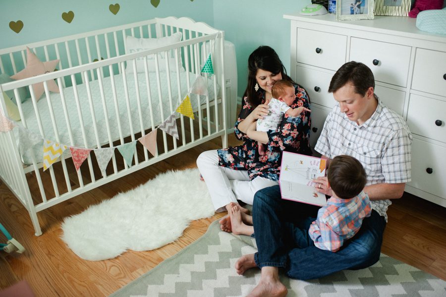 23-family-reading-book-together-in-nursery