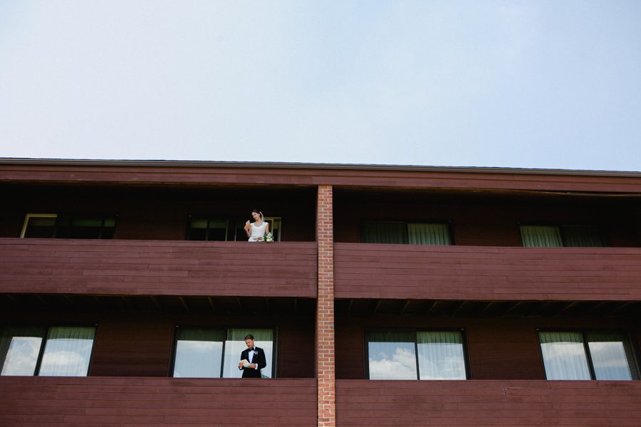 17-bride-and-groom-on-seperate-balconies-at-hotel