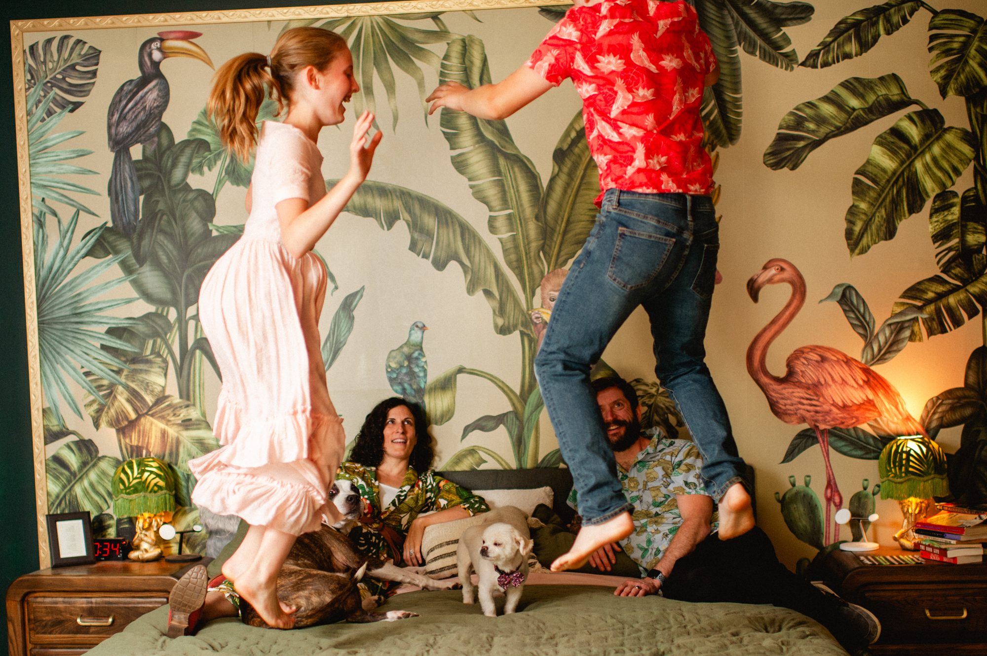 kids jump on their parents bed at an in-home Philadelphia family photo session
