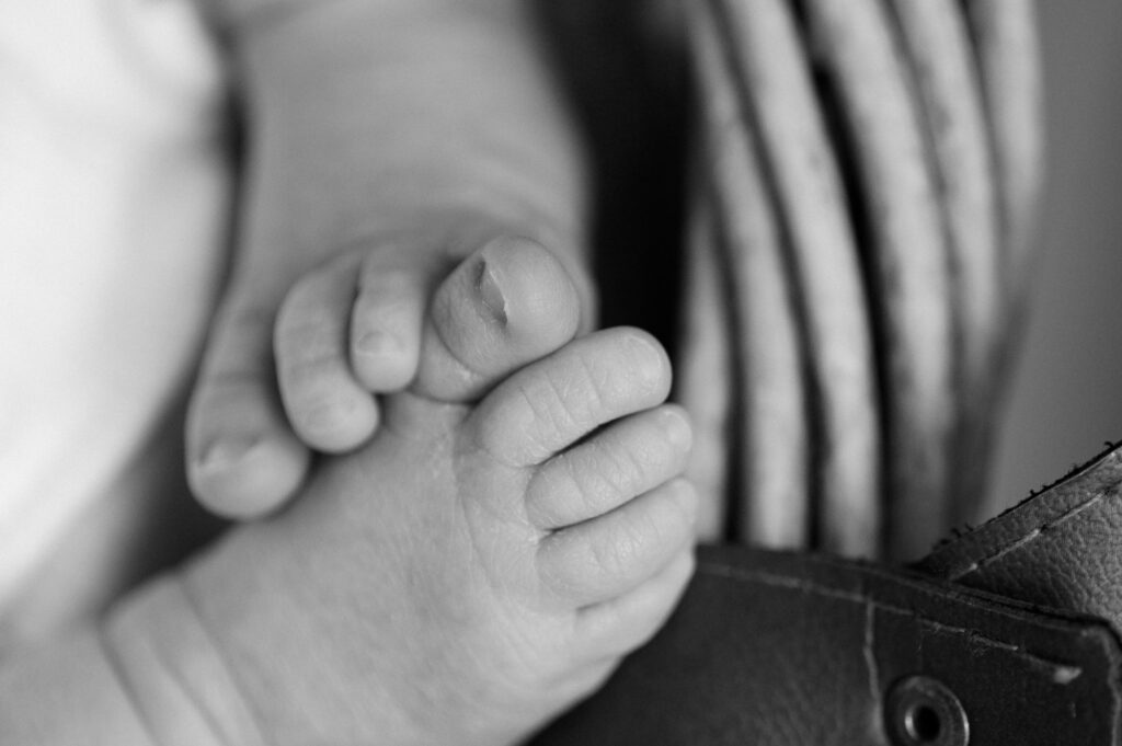 Black and white image of close up of newborn baby's feet