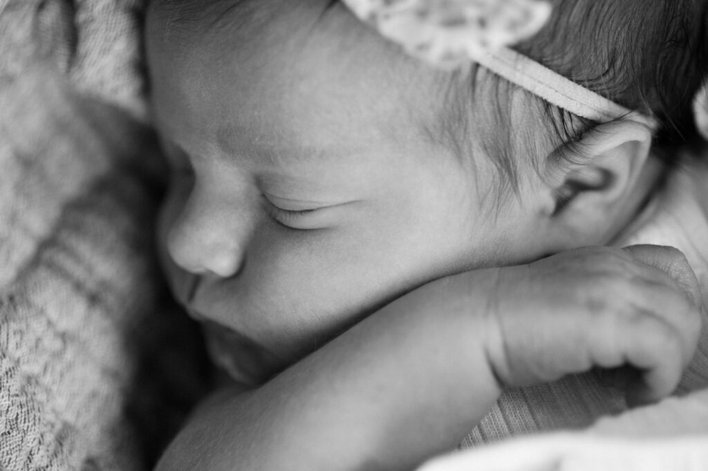 Black and white image of close up of newborn baby's face