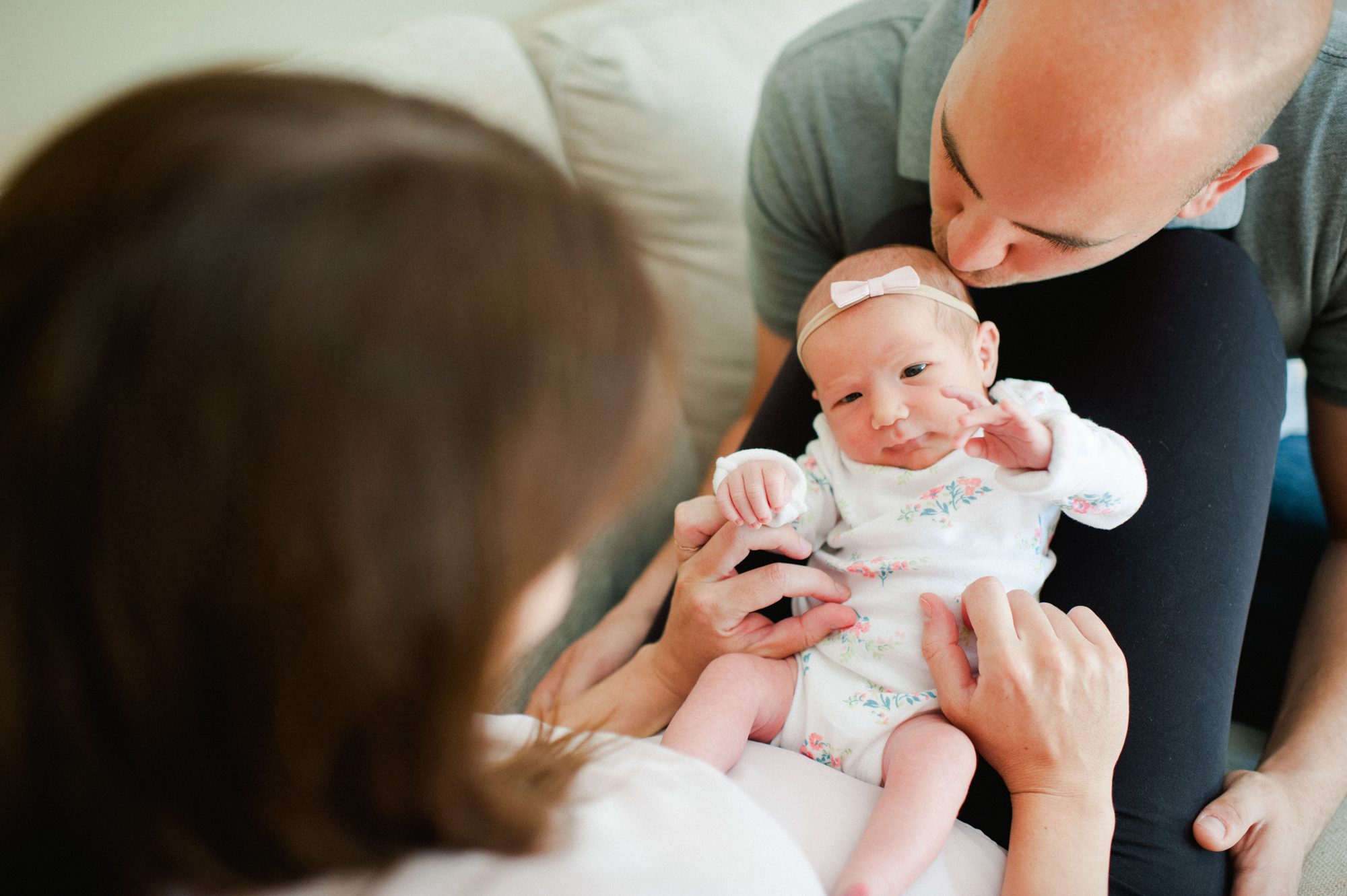 parents looking at newborn baby